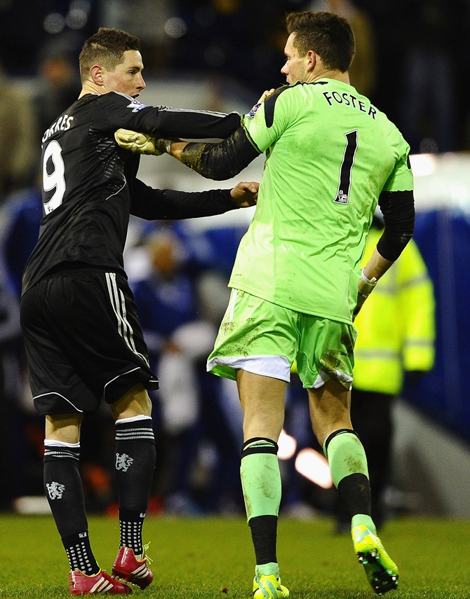 Fernando Torres of Chelsea clashes with Ben Foster of West Brom.