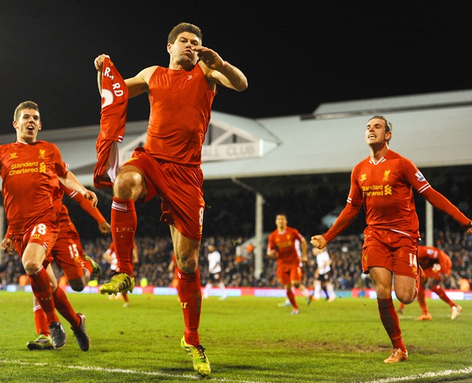 Steven Gerrard of Liverpool celebrates scoring their third goal from the penalty spot.