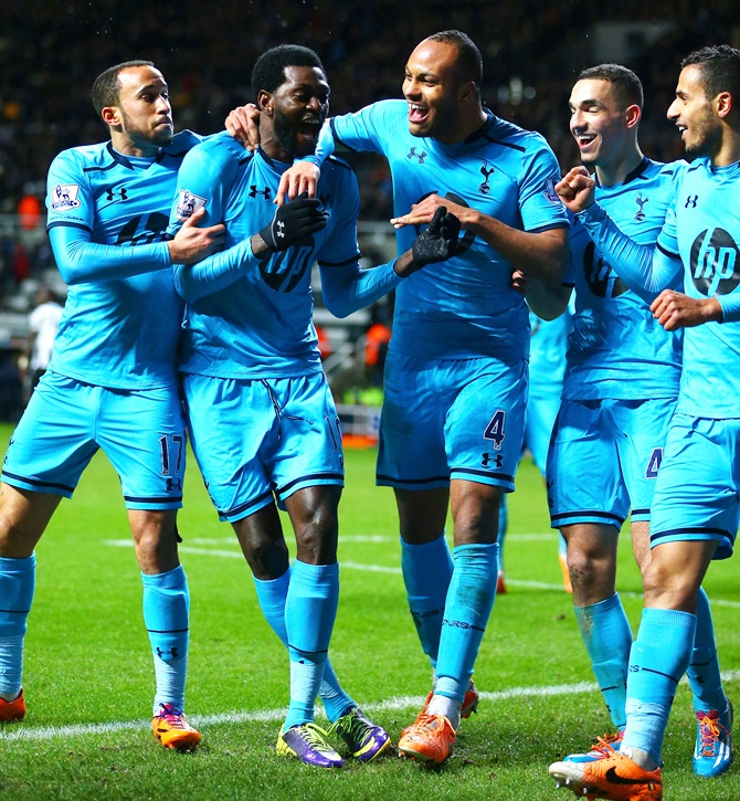 Emmanuel Adebayor of Tottenham Hotspur, second right, celebrates scoring their third goal with teammates.