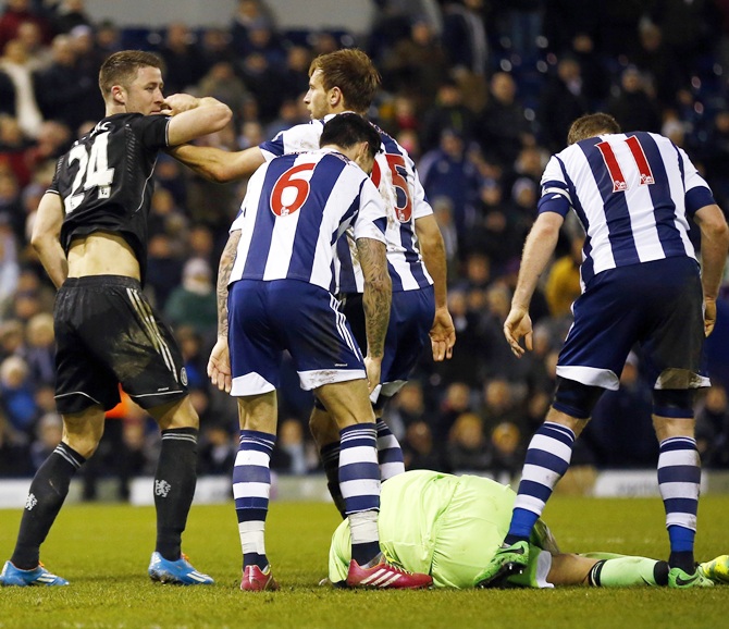 Chelsea's Gary Cahill,left, reacts as West Bromwich Albion's Ben Foster lies on the ground after the final whistle.
