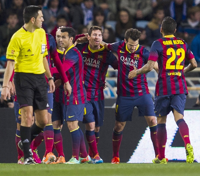 Lionel Messi,centre, of FC Barcelona celebrates after scoring.