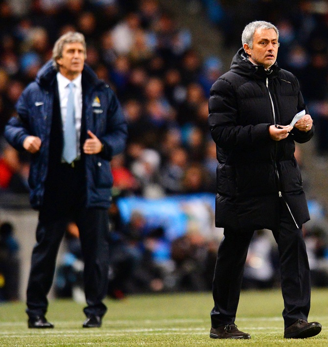 Manuel Pellegrini manager of Manchester City and Jose Mourinho manager of Chelsea give instructions.