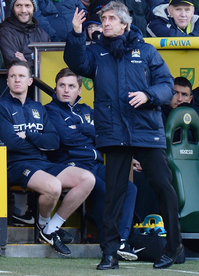 Manuel Pellegrini, manager of Manchester City shouts his instructions fron the bench.