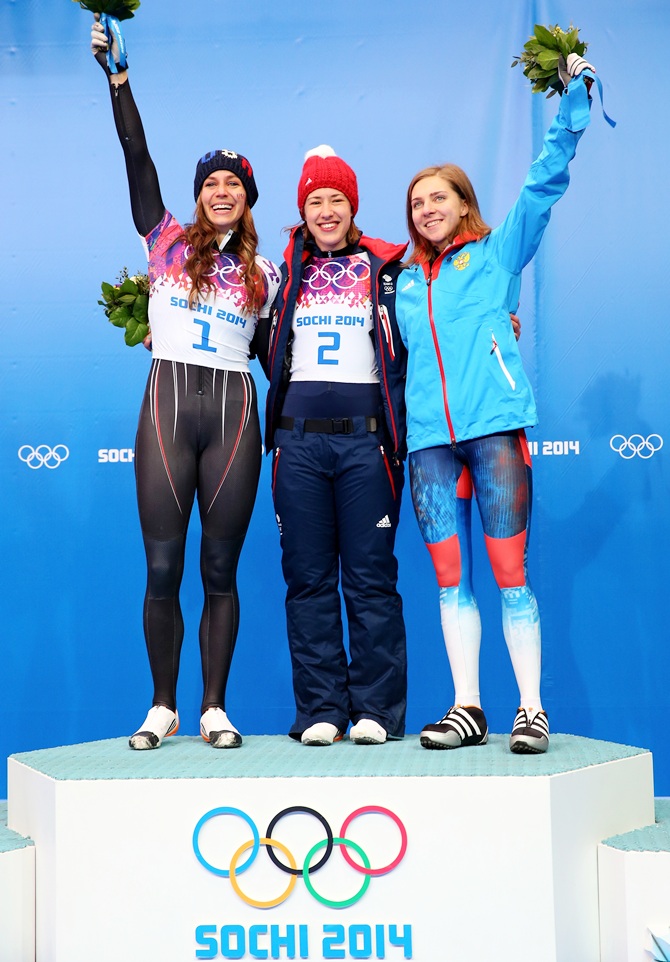 From left, Silver medalist Noelle Pikus-Pace of the United States, gold medalist Lizzy Yarnold of Great Britain and bronze medalist Elena Nikitina of Russia celebrate on the podium