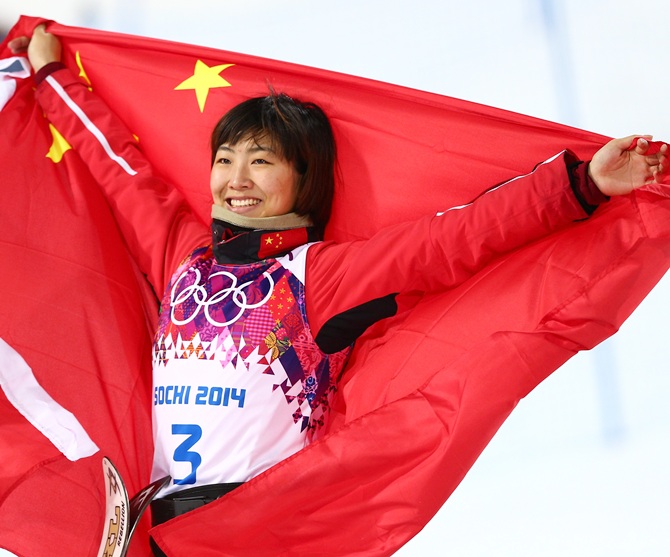 Silver medalist Xu Mengtao of China celebrates during the flower ceremony.