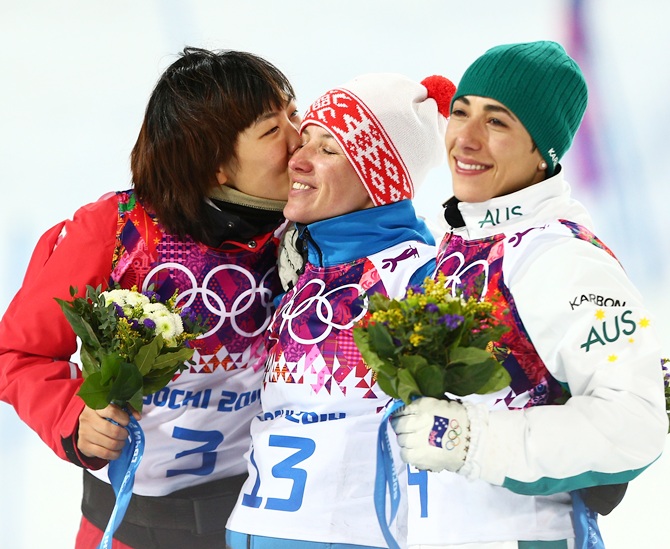 From left, Silver medalist Xu Mengtao of China, gold medalist Alla Tsuper of Belarus and bronze medalist Lydia Lassila of Australia celebrate on the podium.