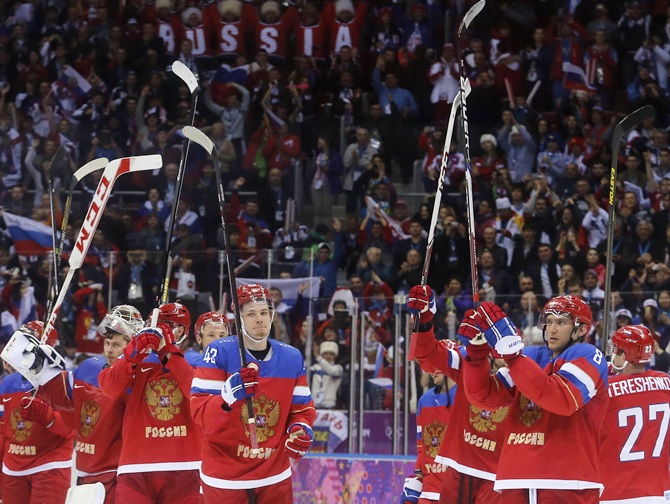 Russian men's ice hockey team celebrate winning against Slovenia.