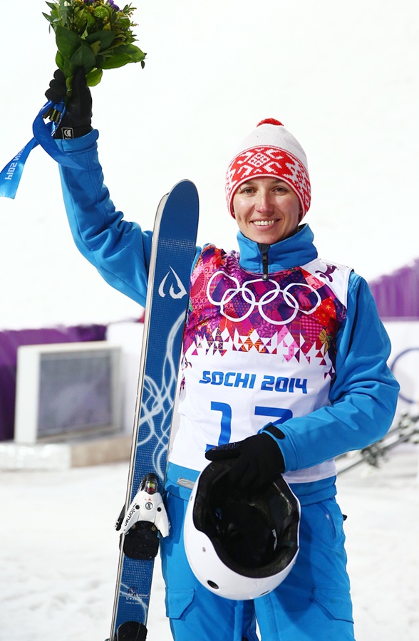 Gold medalist Alla Tsuper of Belarus celebrates during the flower ceremony.
