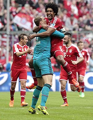 Bayern Munich's goalkeeper Manuel Neuer and Dante celebrate a goal during their Bundesliga match against Freiburg in Munich on Sarurday