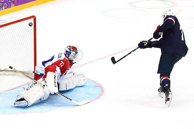 T.J. Oshie #74 of the United States scores on a shootout against Sergei Bobrovski #72 of Russia during the Men's Ice Hockey Preliminary Round Group A game at Bolshoy Ice Dome on Saturday