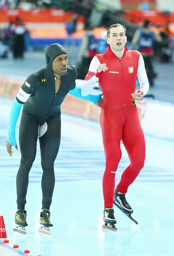 Zbigniew Brodka of Poland is congratulated by Shani Davis of US during the Speed Skating Men's 1500m at Adler Arena Skating Center on Saturday