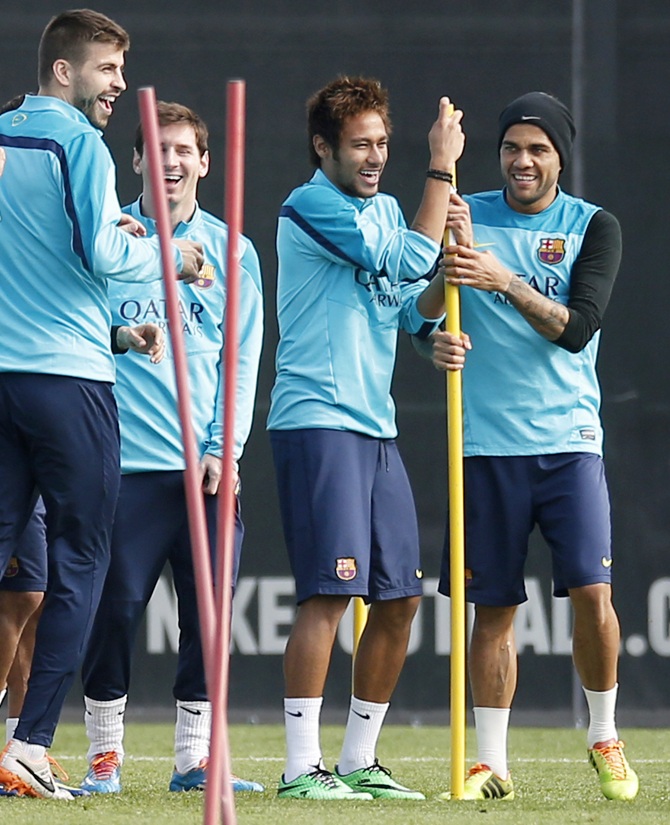 From left, Barcelona's players Gerard Pique, Lionel Messi, Neymar and Dani Alves joke during a training session.