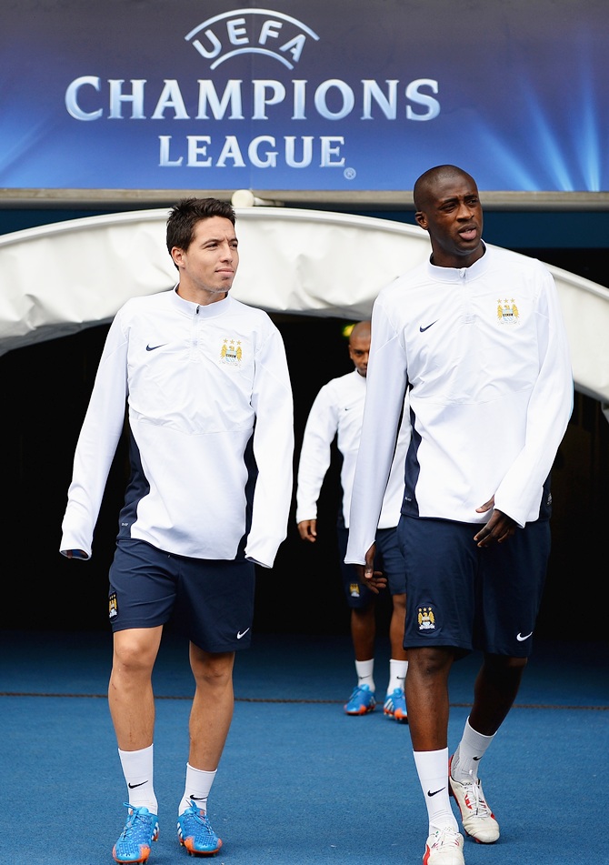 Samir Nasri and Yaya Toure of Manchester City emerge from the tunnel ahead of a trainng session.