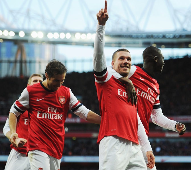 Lukas Podolski, left, of Arsenal celebrates with team mate Yaya Sanogo after scoring.