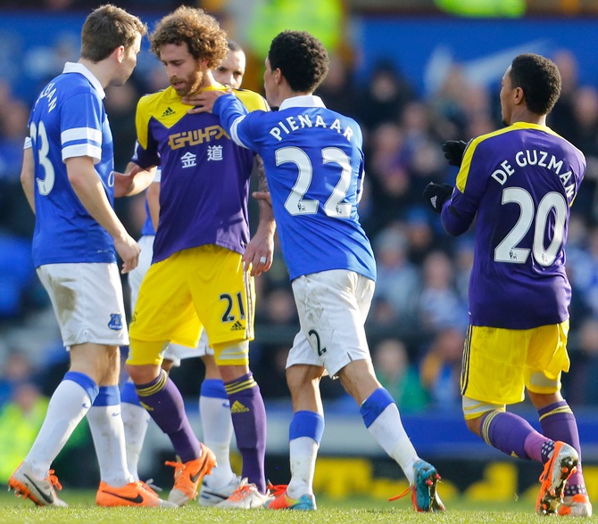 Steven Pienaar, centre, of Everton pushes Jose Canas of Swansea City in an altercation.