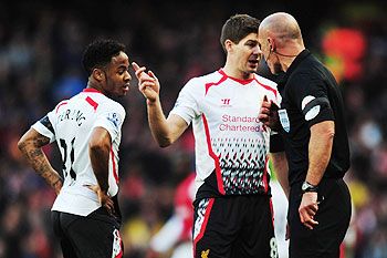 Raheem Sterling and Steven Gerrard argue with ref Howard Webb during their FA Cup match on Sunday