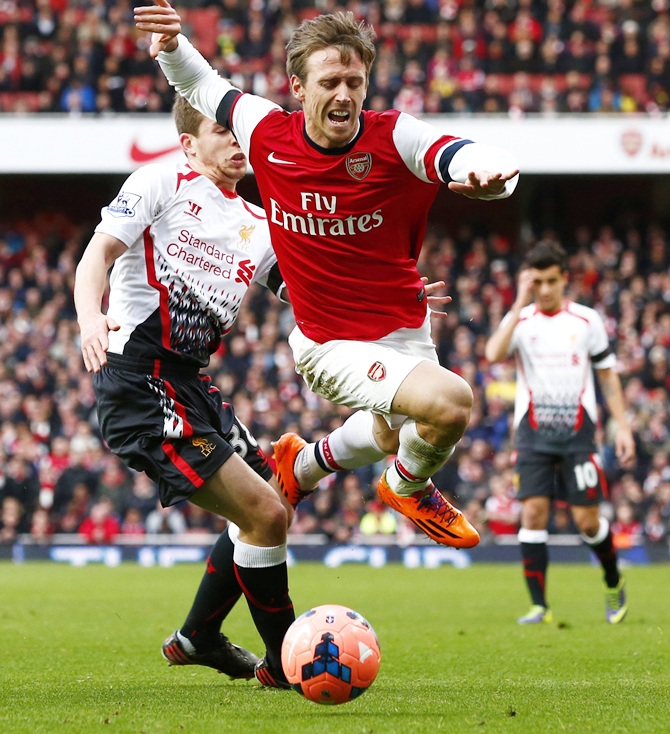 Arsenal's Nacho Monreal, right, is fouled by Liverpool's Jon Flanagan during their FA Cup match.