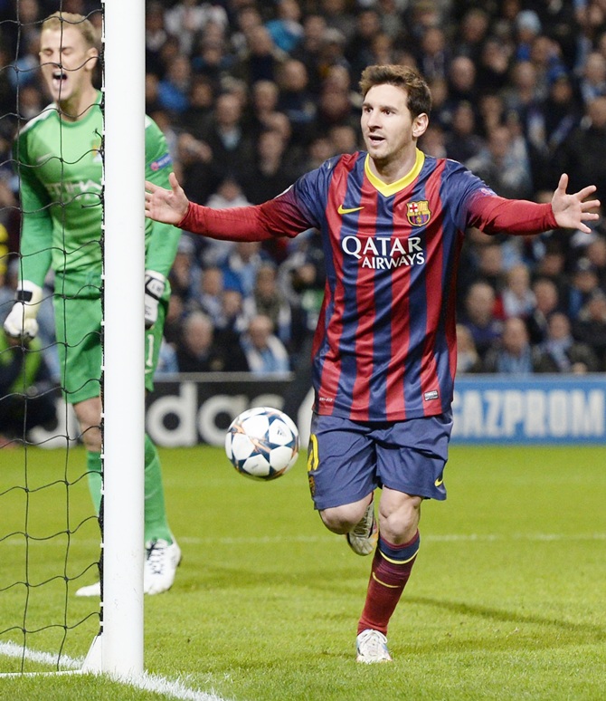 Barcelona's Lionel Messi, right, celebrates after scoring a penalty past Manchester City's goalkeeper Joe Hart.
