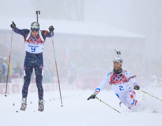 Martin Fourcade of France stretches for the finish line next to Emil Hegle Svendsen of Norway.
