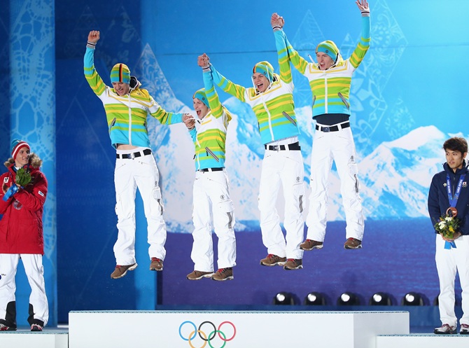 From left, Gold medalists Andreas Wank, Marinus Kraus, Andreas Wellinger and Severin Freund of Germany celebrate during the medal ceremony for the Men's Team Ski Jumping.