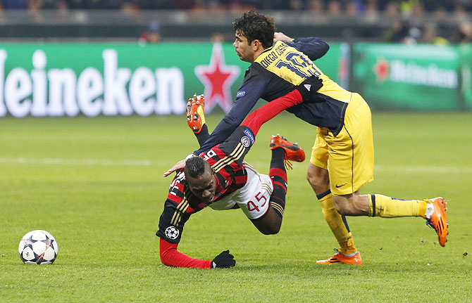 AC Milan's Mario Balotelli (left) is tackled by Atletico Madrid's Diego Costa on Wednesday