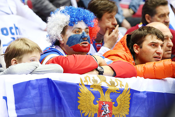 A dejected Russian fan watches the Men's Ice Hockey Quarterfinal Playoff against Finland at the 2014 Sochi Winter Olympics at Bolshoy Ice Dome on Wednesday