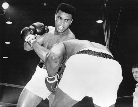 Cassius Clay (now Muhammad Ali) in action against Sonny Liston during their heavyweight title fight at Miami Beach, Florida. Clay won when Liston failed to come out in the seventh round. Photograph: Allsport/Hulton Archive/Getty Images