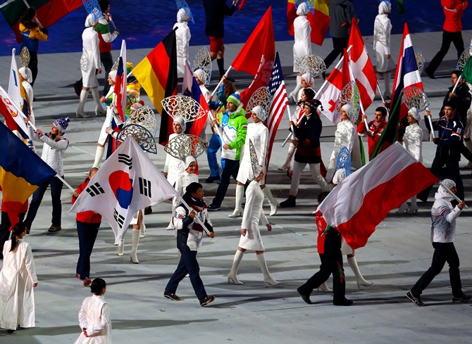 The flags of the competiting nations enter the arena during the 2014 Sochi Winter Olympics Closing Ceremony.