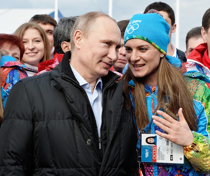 Russian President Vladimir Putin speaks with Olympic Village Mayor Elena Isinbaeva.