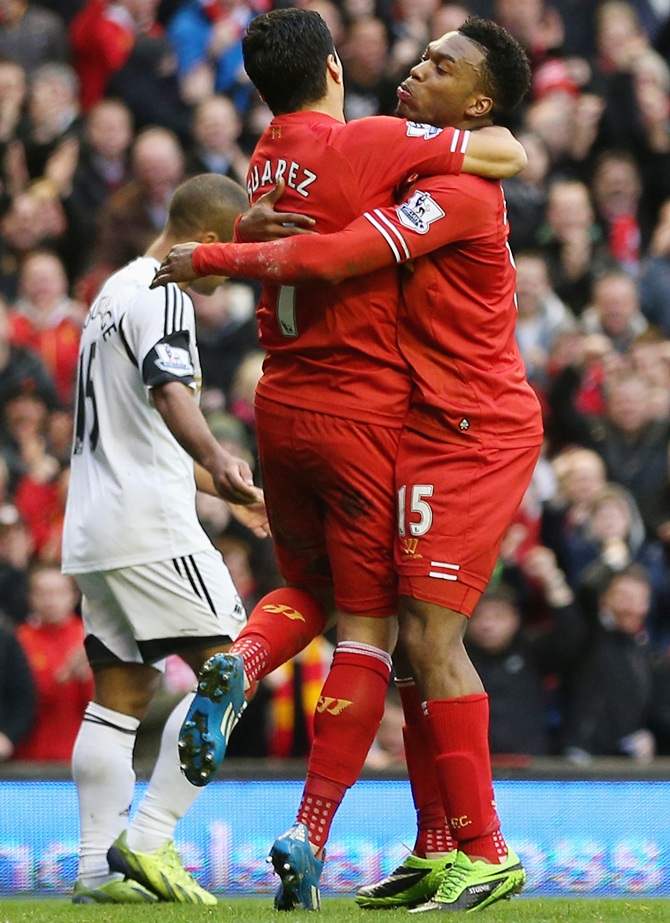 Daniel Sturridge, left, of Liverpool celebrates scoring his team's third goal with Luis Suarez.