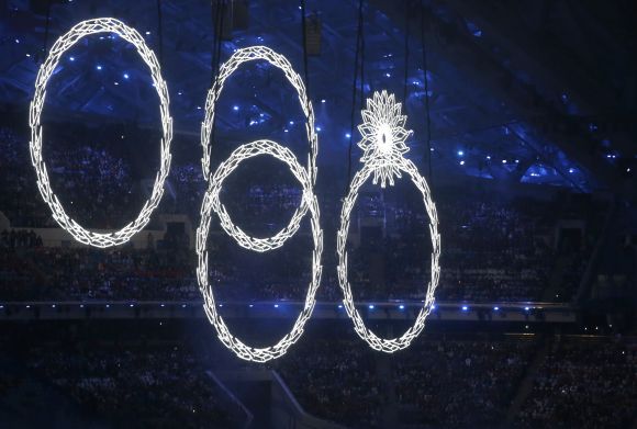 Four out of five of the Olympic rings are seen lit up during the opening ceremony.