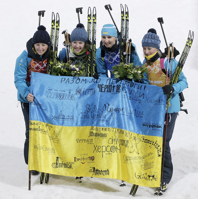 Gold medalists Vita Semerenko, Juliya Dzhyma, Olena Pidhrushna and Valj Semerenko of Ukraine celebrate after   the flower ceremony for the Biathlon Women's 4 x 6 km Relay.