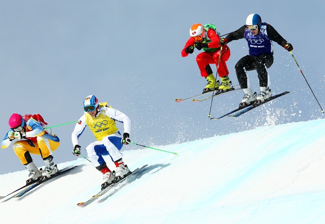 Victor Oehling Norberg of Sweden (red bib), Egor Korotkov of Russia (yellow bib), Armin Niederer of Switzerland (green bib) and Jouni Pellinen of Finland (blue bib) compete during the Freestyle Skiing Men's Ski Cross 1/8 Finals.