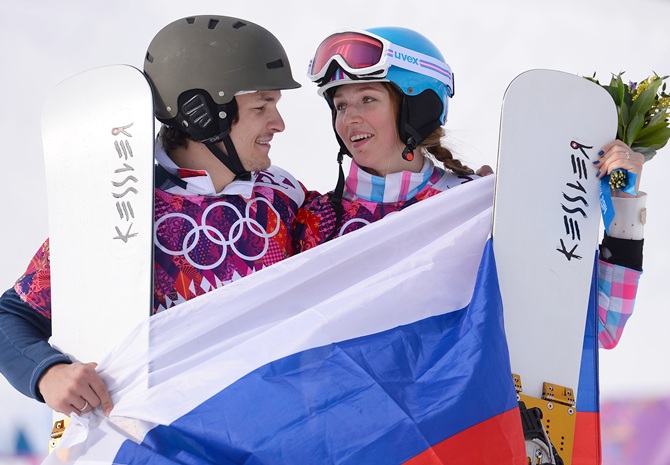 Men's gold medalist Vic Wild of Russia and women's bronze medalist Alena Zavarzina of Russia celebrate.