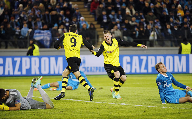 Borussia Dortmund's Robert Lewandowski and Lukasz Piszczek (2nd from right) celebrate a goal against Zenit St Petersburg during their Champions League round of 16 first leg match at the Petrovsky stadium in St. Petersburg on Tuesday