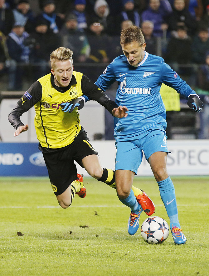 Zenit St Petersburg's Domenico Criscito (right) and Borussia Dortmund's Marco Reus vie for possession during their Champions League match on Tuesday