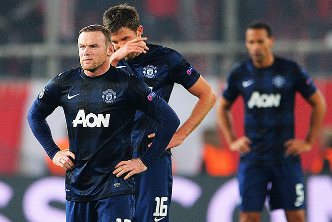 Wayne Rooney and Michael Carrick of Manchester United react after conceding their second goal against Olympiacos FC during the UEFA Champions League Round of 16 first leg match at Karaiskakis Stadium on Tuesday