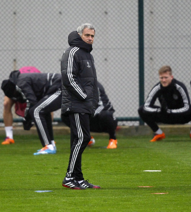 Chelsea manager Jose Mourinho, centre, attends a training session.