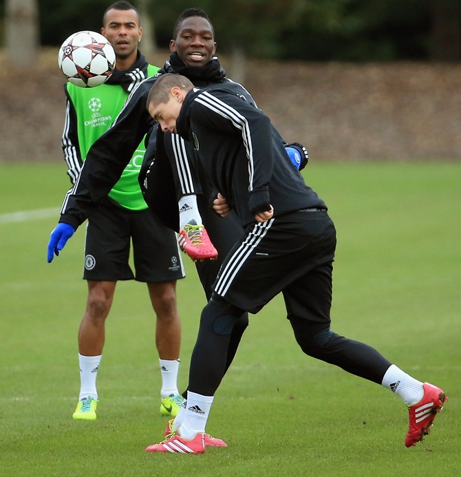 Fernando Torress gets clipped by Kenneth Omeruo as he goes to head the ball during the Chelsea FC training session.