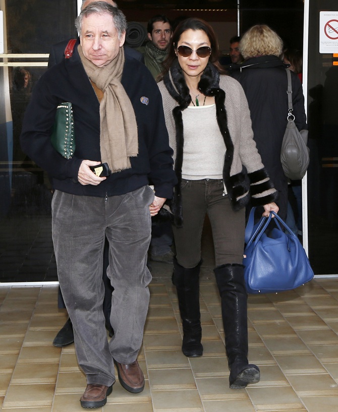 Former Ferrari team manager and current FIA President Jean Todt (left) and his girlfriend actress Michelle Yeoh leave the CHU hospital emergency unit in Grenoble, French Alps