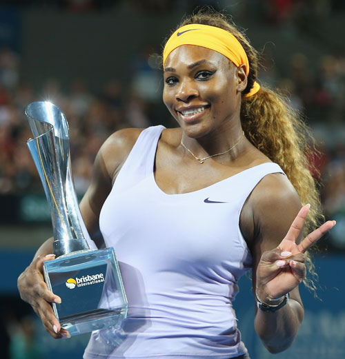 Serena Williams of the USA poses with the winners trophy after winning her final against Victoria Azarenka of Belarus at the 2014 Brisbane International