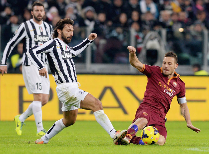 Andrea Pirlo (left) of FC Juventus and Francesco Totti of AS Roma vie for possession during the Serie A match at Juventus Arena in Turin on Sunday