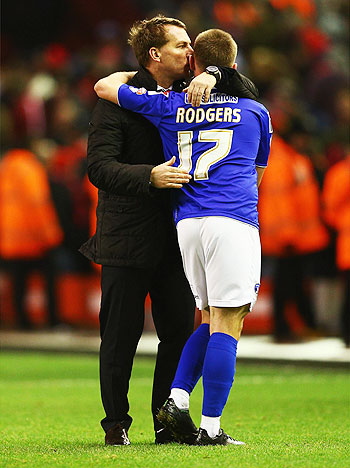 Liverpool manager Brendan Rodgers (left) kisses son Anton Rodgers of Oldham Athletic after their FA Cup third round match at Anfield on Sunday