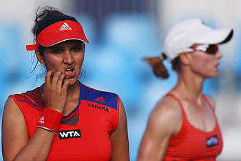 Cara Black of Zimbabwe and Sania Mirza of India look on during their match against Jarmila Gajdosova of Slovakia and Ajla Tomljanovic of Croatia on Day 2 of the Sydney International at Sydney Olympic Park Tennis Centre on Monday