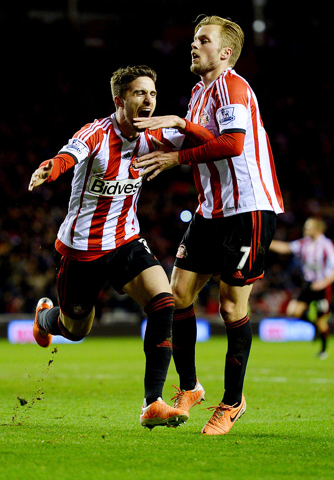 Fabio Borini of Sunderland (left) celebrates with Sebastian Larsson (right) as he scores their second goal from the penalty spot during the League Cup semi-final, first leg match against Manchester United at the Stadium of Light in Sunderland on Tuesday