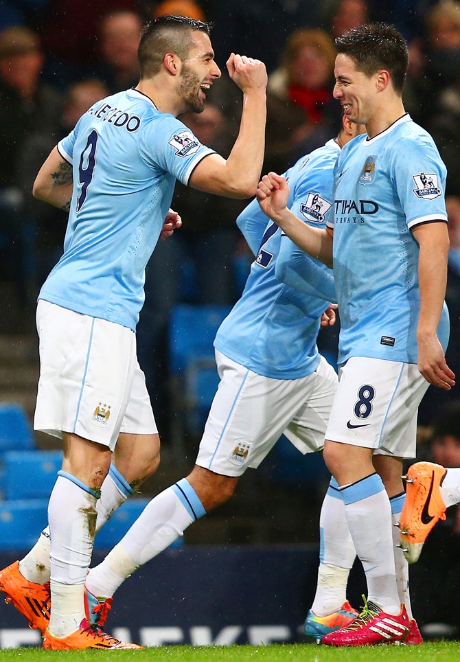 Alvaro Negredo of Manchester City celebrates scoring the opening goal with Samir Nasri