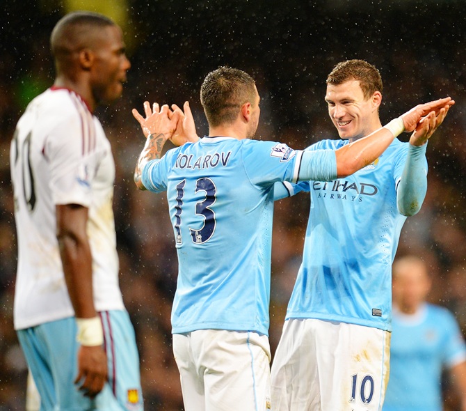 Edin Dzeko of Manchester City celebrates scoring their sixth goal with Aleksandar Kolarov
