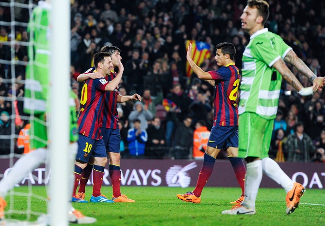 Lionel Messi of FC Barcelona celebrates with his teammates
