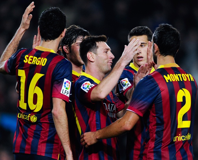 Lionel Messi of FC Barcelona celebrates with his teammates after scoring his team's third goal