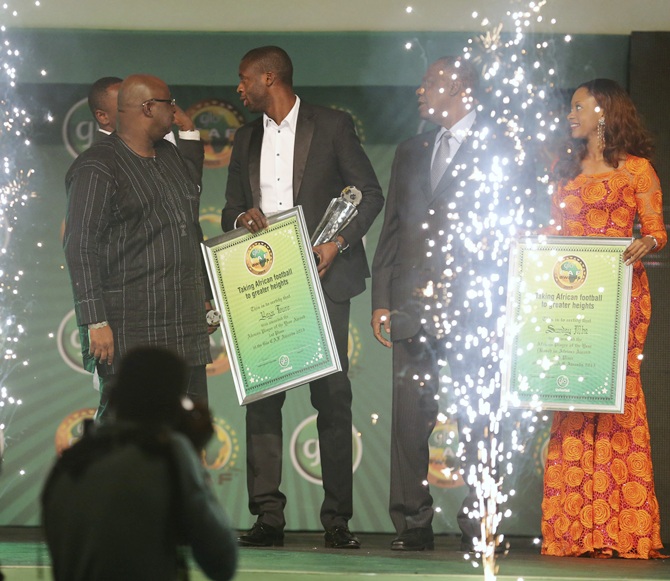 Manchester City and Ivory Coast midfielder Yaya Toure (centre) holds his   plaque after winning the African Footballer of the Year at the 2013 Confederation of African Football (CAF) Awards ceremony in Lagos